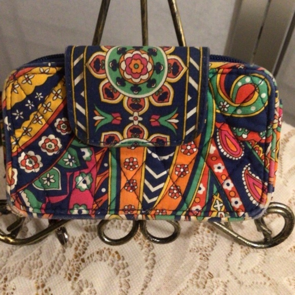 Vera Bradley colorful small wallet and cell phone.